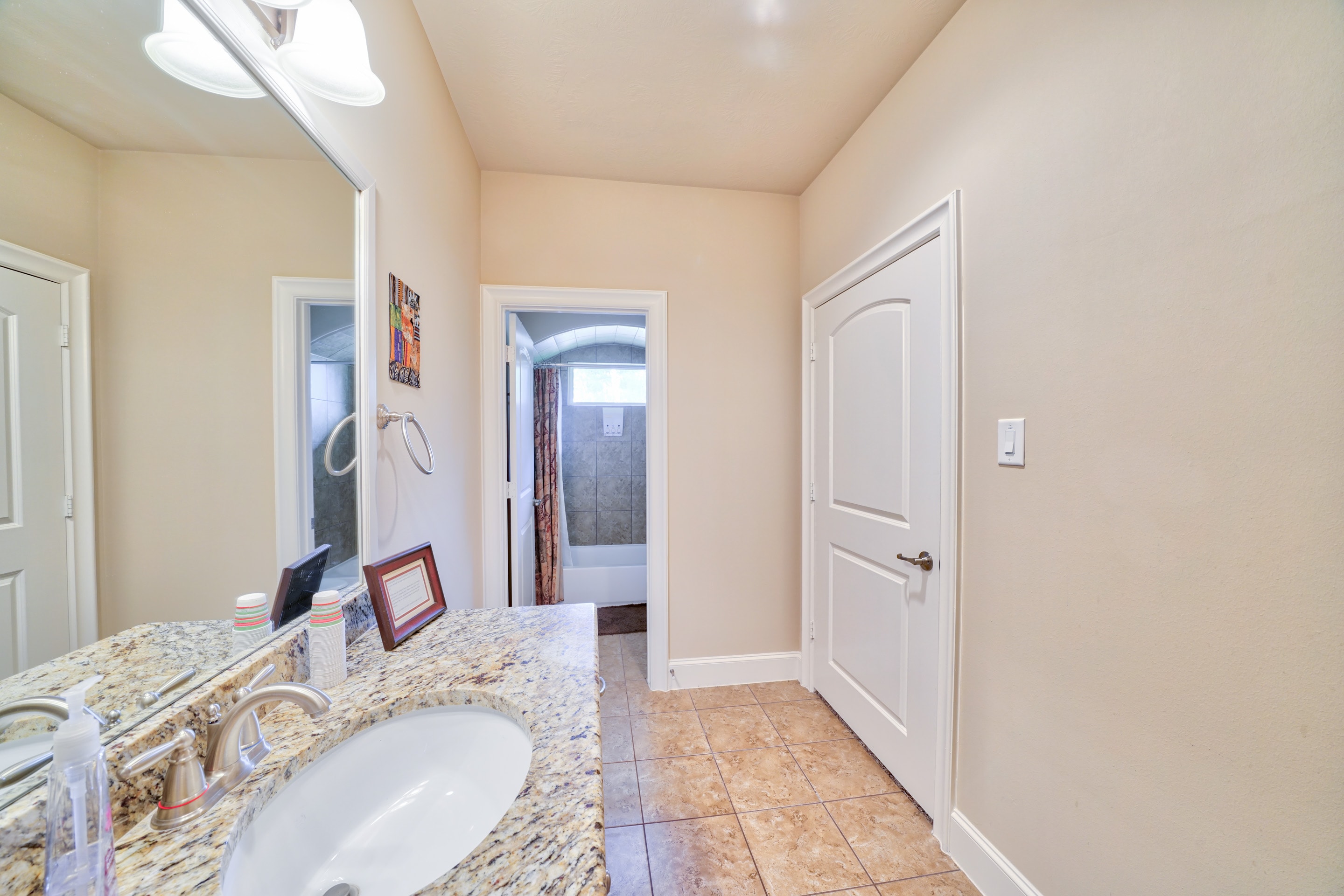 Spacious private bathroom with granite countertop and shower