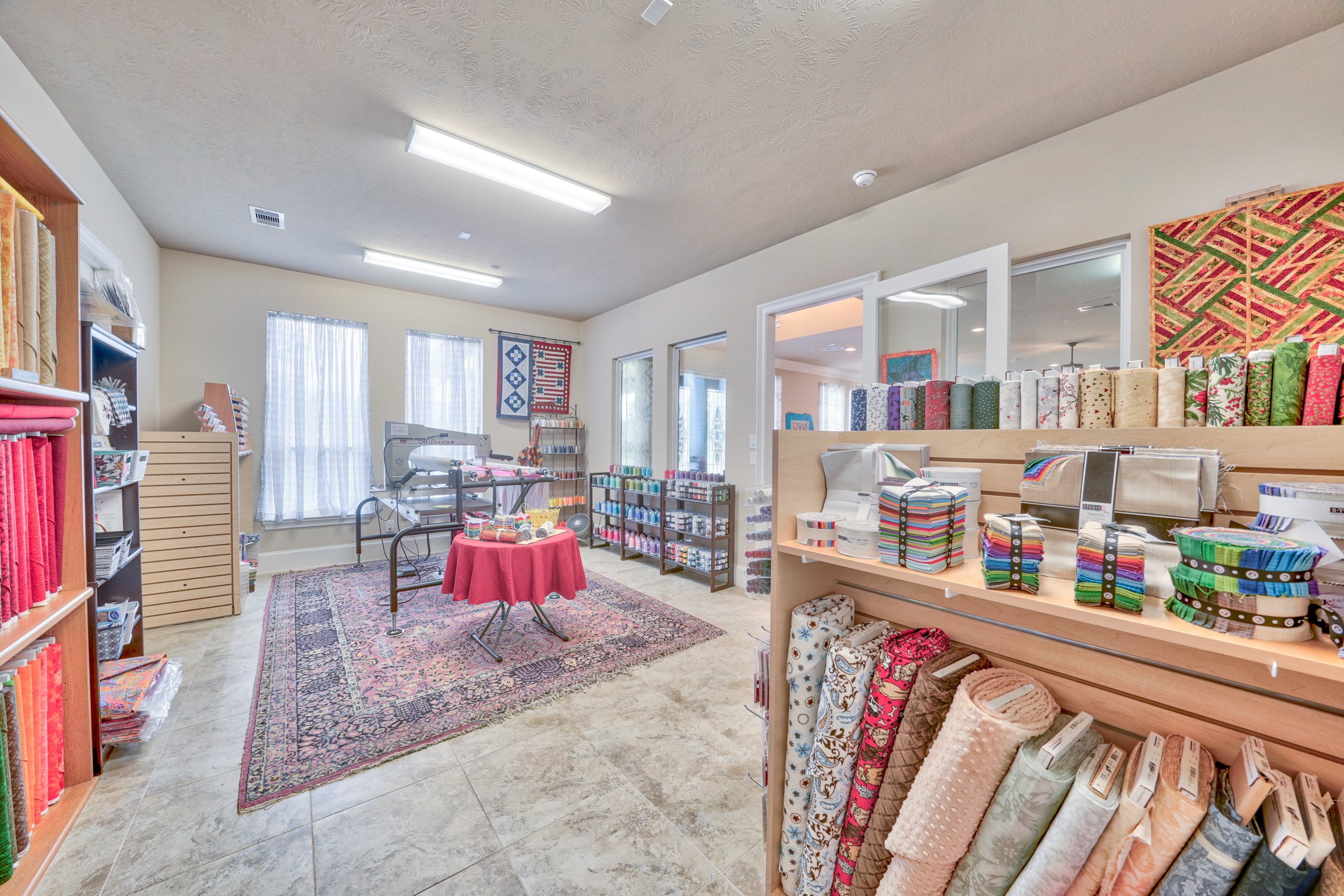 On-site quilting store with fabric bolts, batting, and quilting supplies